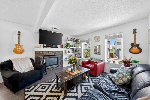 194 Everoak Gardens Sw, Calgary, AB - Indoor Photo Showing Living Room With Fireplace