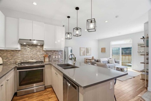2-4733 17 Avenue Nw, Calgary, AB - Indoor Photo Showing Kitchen With Stainless Steel Kitchen With Double Sink With Upgraded Kitchen