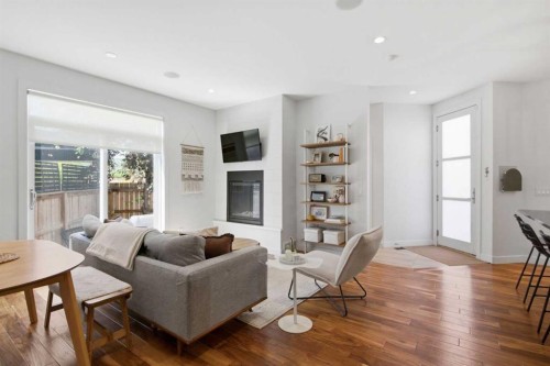 2-4733 17 Avenue Nw, Calgary, AB - Indoor Photo Showing Living Room With Fireplace