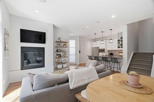 2-4733 17 Avenue Nw, Calgary, AB - Indoor Photo Showing Living Room With Fireplace
