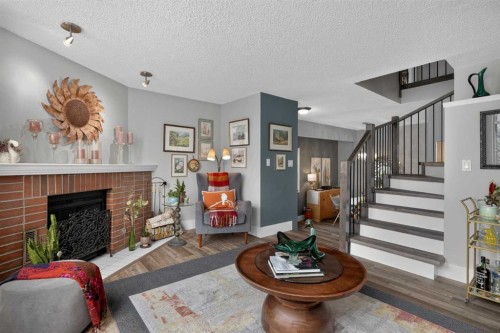 107-1615 13 Avenue Sw, Calgary, AB - Indoor Photo Showing Living Room With Fireplace