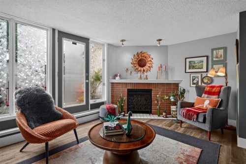 107-1615 13 Avenue Sw, Calgary, AB - Indoor Photo Showing Living Room With Fireplace