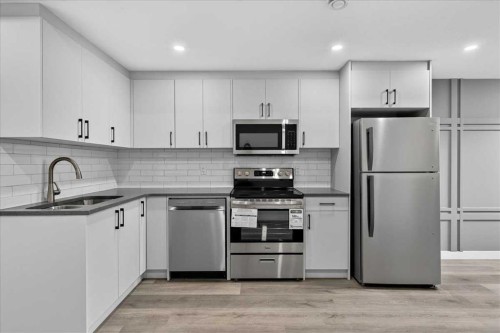 36 Heartwood Lane Se, Calgary, AB - Indoor Photo Showing Kitchen With Double Sink