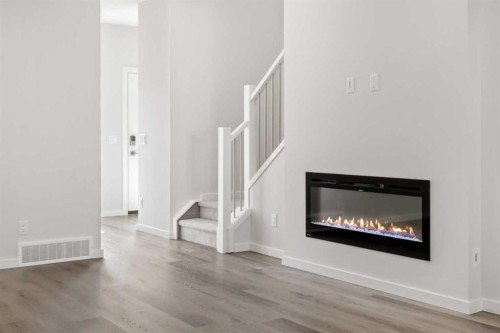 36 Heartwood Lane Se, Calgary, AB - Indoor Photo Showing Living Room With Fireplace