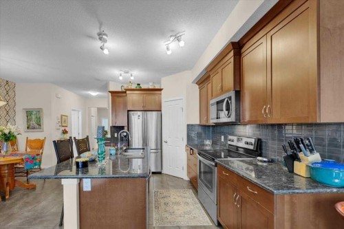 226 Sunset Point, Cochrane, AB - Indoor Photo Showing Kitchen With Double Sink With Upgraded Kitchen