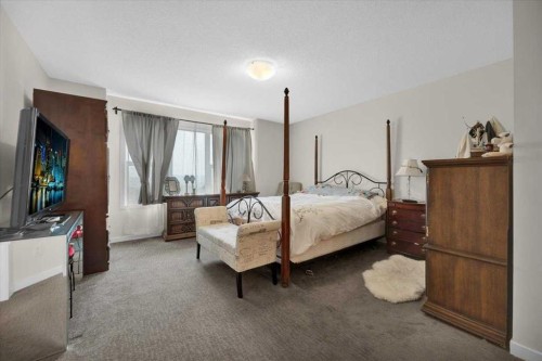 226 Sunset Point, Cochrane, AB - Indoor Photo Showing Bedroom