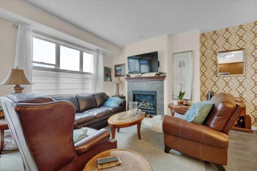 226 Sunset Point, Cochrane, AB - Indoor Photo Showing Living Room With Fireplace