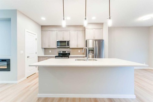 105 Highview Gate Se, Airdrie, AB - Indoor Photo Showing Kitchen With Double Sink With Upgraded Kitchen