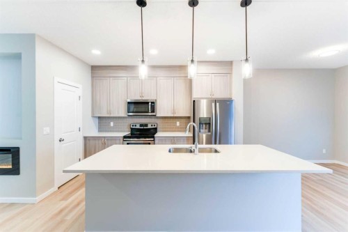 105 Highview Gate Se, Airdrie, AB - Indoor Photo Showing Kitchen With Double Sink With Upgraded Kitchen