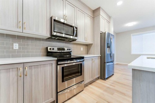 105 Highview Gate Se, Airdrie, AB - Indoor Photo Showing Kitchen With Upgraded Kitchen