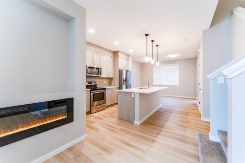 105 Highview Gate Se, Airdrie, AB - Indoor Photo Showing Kitchen With Fireplace With Upgraded Kitchen