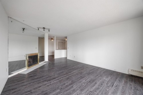 417-333 Garry Crescent Ne, Calgary, AB - Indoor Photo Showing Other Room With Fireplace