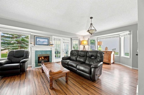 128 Sienna Park Green Sw, Calgary, AB - Indoor Photo Showing Living Room With Fireplace