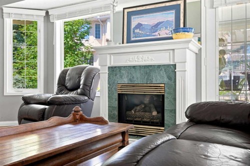 128 Sienna Park Green Sw, Calgary, AB - Indoor Photo Showing Living Room With Fireplace