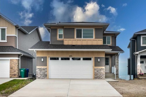 495 Rivercrest View, Cochrane, AB - Outdoor With Facade