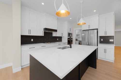 500 Rivercrest View, Cochrane, AB - Indoor Photo Showing Kitchen With Double Sink With Upgraded Kitchen