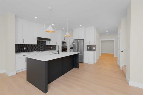 500 Rivercrest View, Cochrane, AB - Indoor Photo Showing Kitchen With Upgraded Kitchen