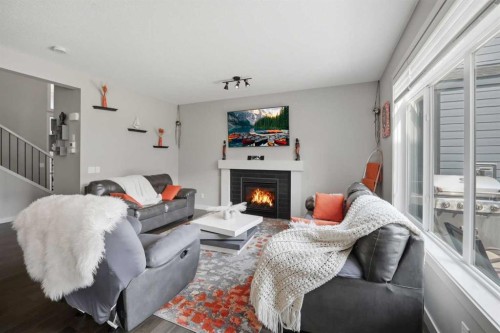 52 Sunrise Way, Cochrane, AB - Indoor Photo Showing Living Room With Fireplace