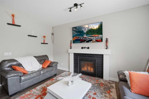 52 Sunrise Way, Cochrane, AB - Indoor Photo Showing Living Room With Fireplace