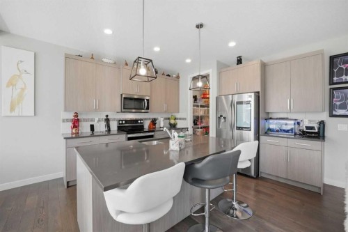 52 Sunrise Way, Cochrane, AB - Indoor Photo Showing Kitchen With Upgraded Kitchen