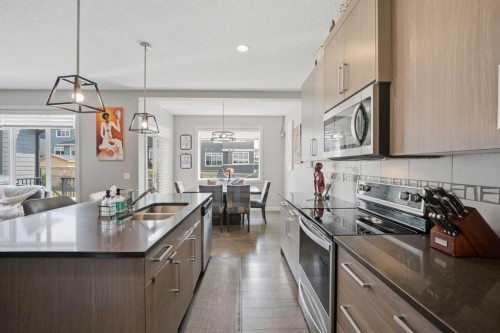 52 Sunrise Way, Cochrane, AB - Indoor Photo Showing Kitchen With Double Sink With Upgraded Kitchen