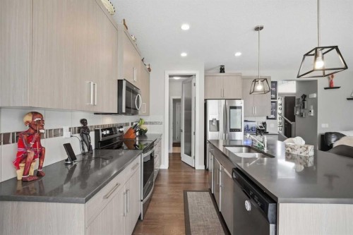 52 Sunrise Way, Cochrane, AB - Indoor Photo Showing Kitchen With Double Sink With Upgraded Kitchen