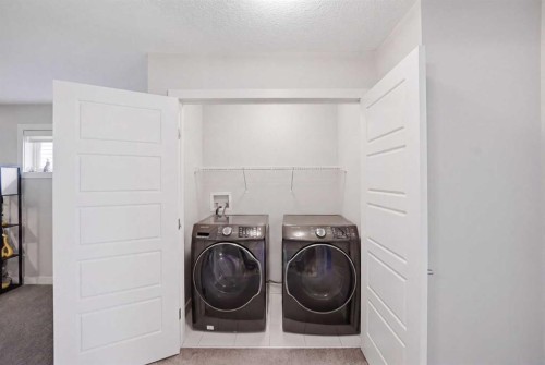 52 Sunrise Way, Cochrane, AB - Indoor Photo Showing Laundry Room