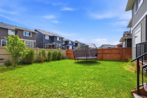 52 Sunrise Way, Cochrane, AB - Outdoor With Backyard