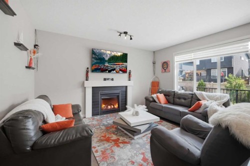 52 Sunrise Way, Cochrane, AB - Indoor Photo Showing Living Room With Fireplace