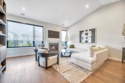 648 Shawnee Terrace Sw, Calgary, AB - Indoor Photo Showing Living Room With Fireplace