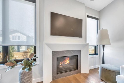 648 Shawnee Terrace Sw, Calgary, AB - Indoor Photo Showing Living Room With Fireplace