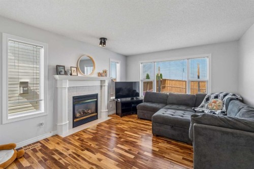 150 Hidden Hills Terrace Nw, Calgary, AB - Indoor Photo Showing Living Room With Fireplace