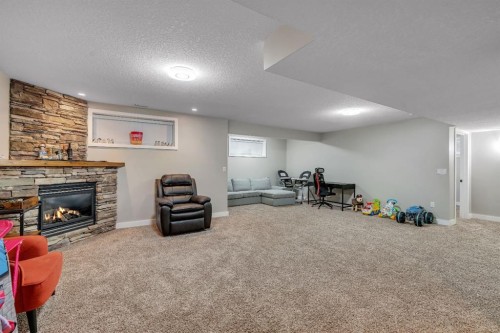 112 Pinto Lane Se, Airdrie, AB - Indoor Photo Showing Basement With Fireplace