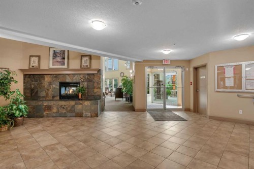 116-428 Chaparral Ravine View Se, Calgary, AB - Indoor Photo Showing Living Room With Fireplace