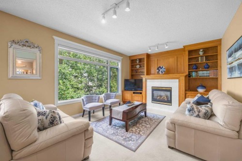 207 Hamptons Drive Nw, Calgary, AB - Indoor Photo Showing Living Room With Fireplace