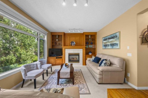 207 Hamptons Drive Nw, Calgary, AB - Indoor Photo Showing Living Room With Fireplace