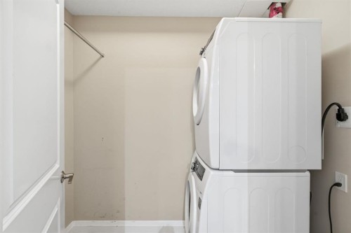 2208-15 Sunset Square, Cochrane, AB - Indoor Photo Showing Laundry Room