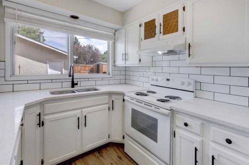 452 Queen Alexandra Way Se, Calgary, AB - Indoor Photo Showing Kitchen With Double Sink