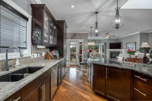 61 River Heights View, Cochrane, AB - Indoor Photo Showing Kitchen With Double Sink With Upgraded Kitchen