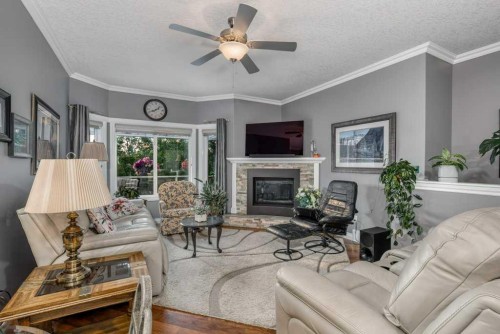 61 River Heights View, Cochrane, AB - Indoor Photo Showing Living Room With Fireplace