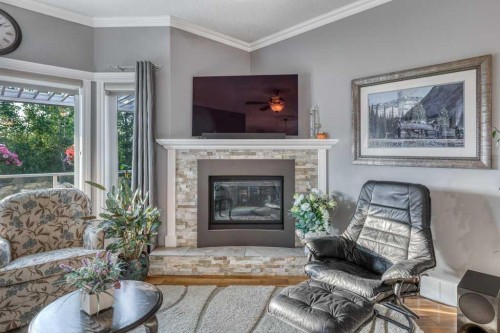 61 River Heights View, Cochrane, AB - Indoor Photo Showing Living Room With Fireplace