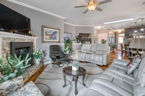 61 River Heights View, Cochrane, AB - Indoor Photo Showing Living Room With Fireplace