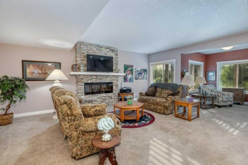 61 River Heights View, Cochrane, AB - Indoor Photo Showing Living Room With Fireplace