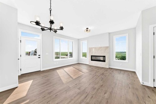 186 Lanark Gate Se, Airdrie, AB - Indoor Photo Showing Living Room With Fireplace