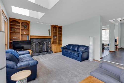 359 Schubert Place Nw, Calgary, AB - Indoor Photo Showing Living Room With Fireplace