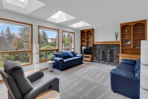 359 Schubert Place Nw, Calgary, AB - Indoor Photo Showing Living Room With Fireplace