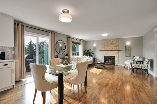 418 Long Beach Landing, Chestermere, AB - Indoor Photo Showing Dining Room With Fireplace