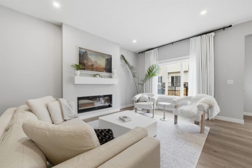 902 Bluerock Way Sw, Calgary, AB - Indoor Photo Showing Living Room With Fireplace