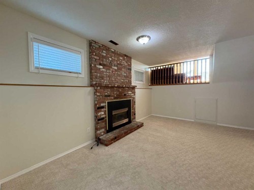 228 Erin Woods Drive Se, Calgary, AB - Indoor Photo Showing Other Room With Fireplace