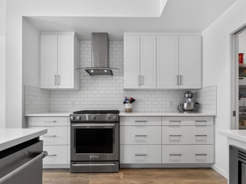 228 Masters Crescent Se, Calgary, AB - Indoor Photo Showing Kitchen With Fireplace With Upgraded Kitchen